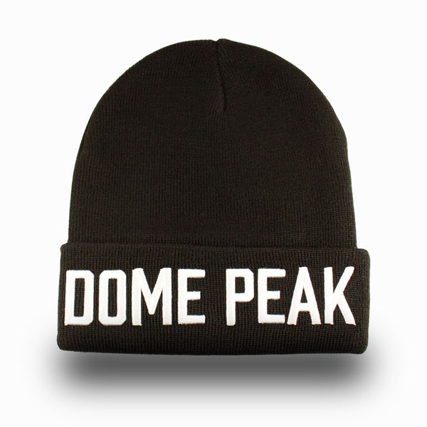 DomePeak Bold, white on black beanie cap. 100% acrylic beanie. Winter wear. Front angle of the cap.